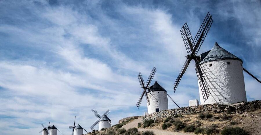 From Madrid: Toledo, Windmills & Alcala de Henares Day Trip - Consuegra and the windmills above La Mancha