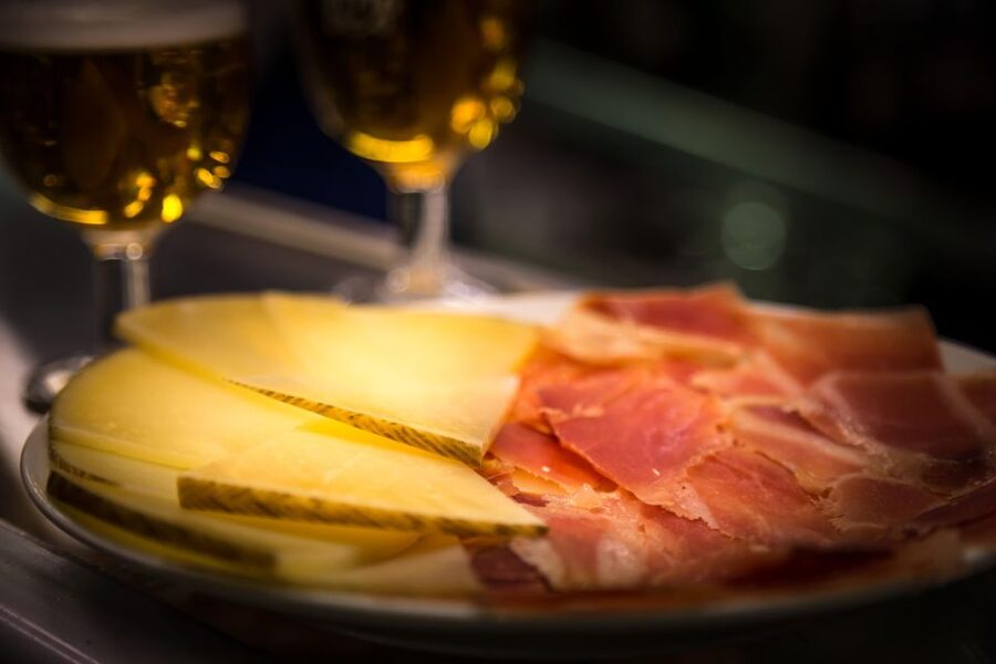Madrid: Authentic Tapas Evening Tour with a side of History - First and second stops: standing tapas and local drinks