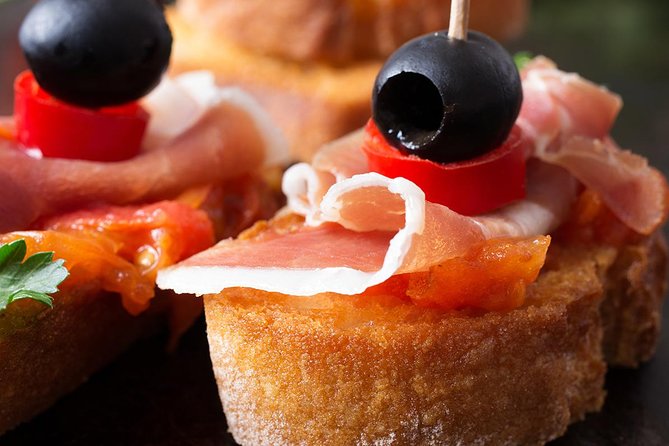 Madrid Tapas Experience Walking Tour - The first spread: paella, croquettes, and jamón Ibérico