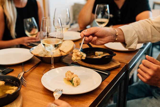 Madrid Tapas & Wine Tour with Rooftop Views and Local Guide - Huertas Street and slow-cooked beef cheeks
