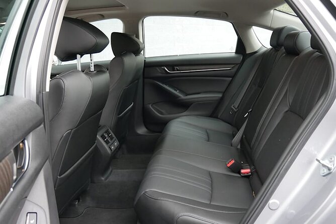 Round Trip Transfer from Madrid Airport MAD to Madrid by Sedan - Walking out of Madrid Airport with a driver waiting